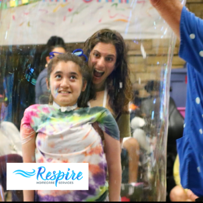 Child with woman behind her looking happy and smiling from celebrating