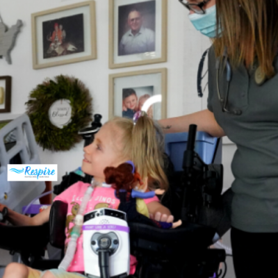 Child with tracheostomy attached sitting in wheelchair smiling at woman